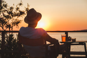 Man sitting looking at sunset